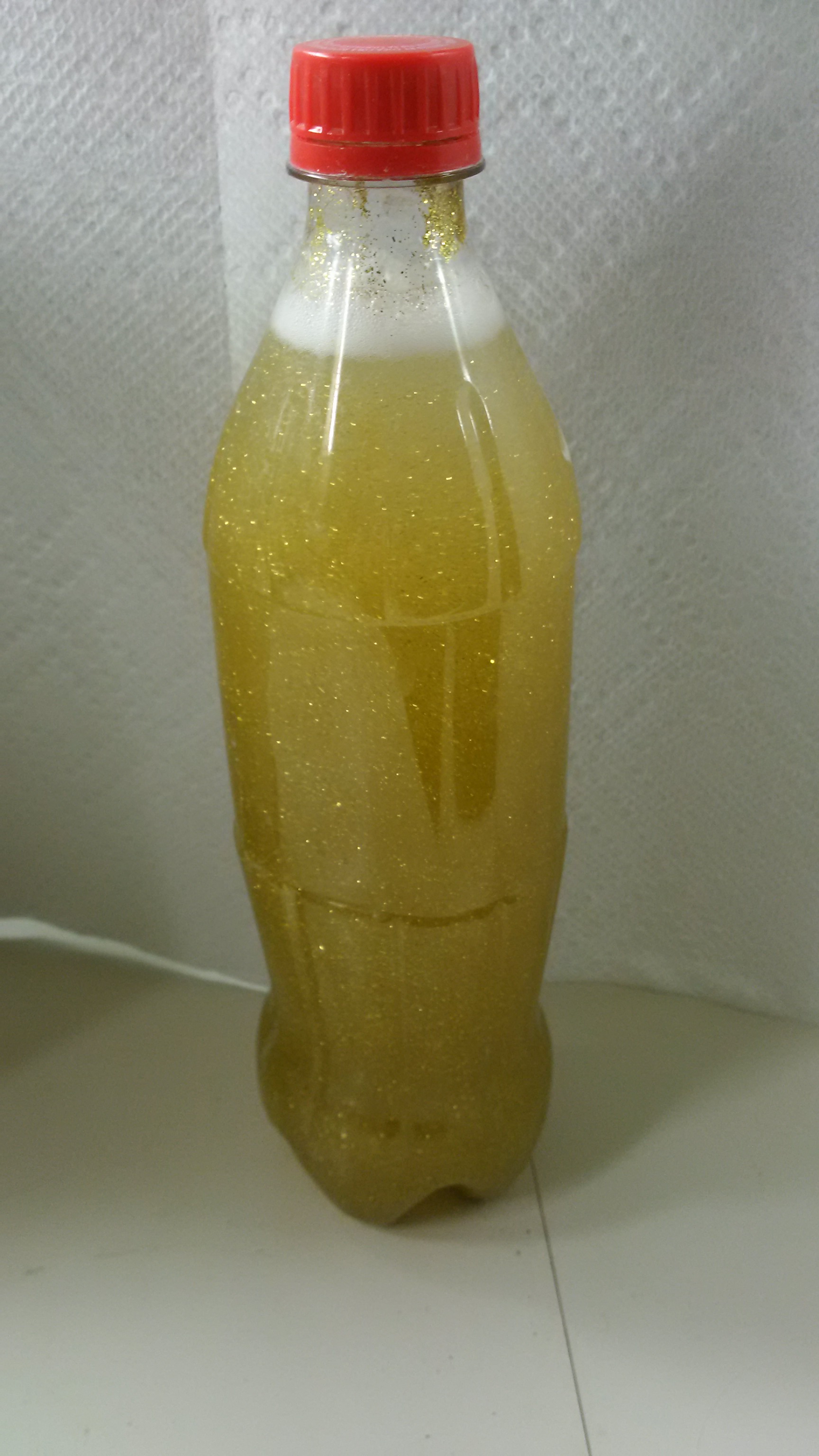 a 500ml coke bottle filled with water and glitter