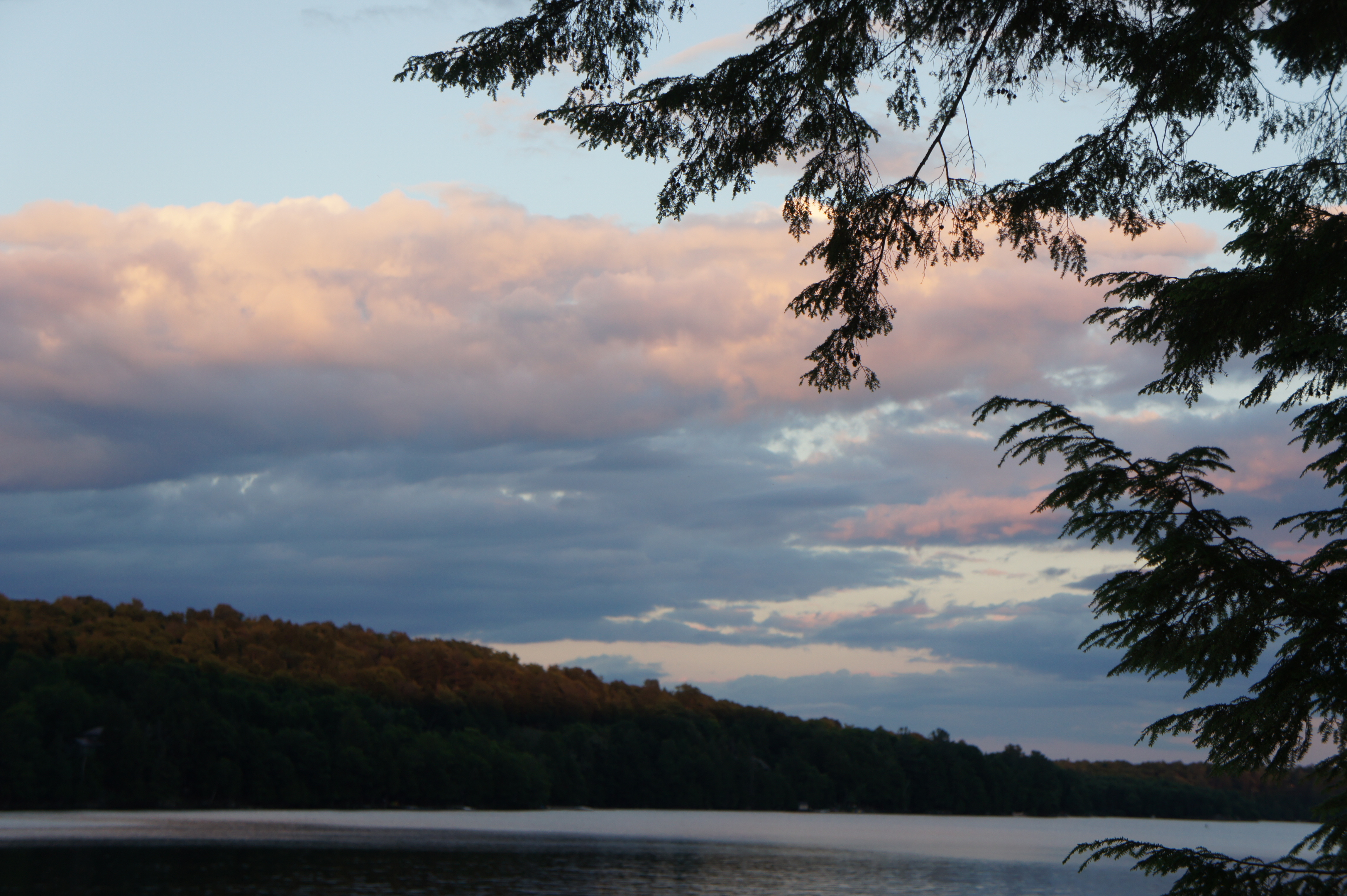 big fluffy clouds over a lake